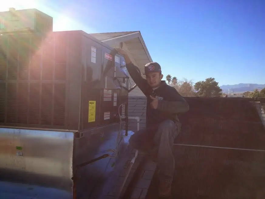 HVAC technician performing HVAC Inspection on a rooftop unit in Lower Merion